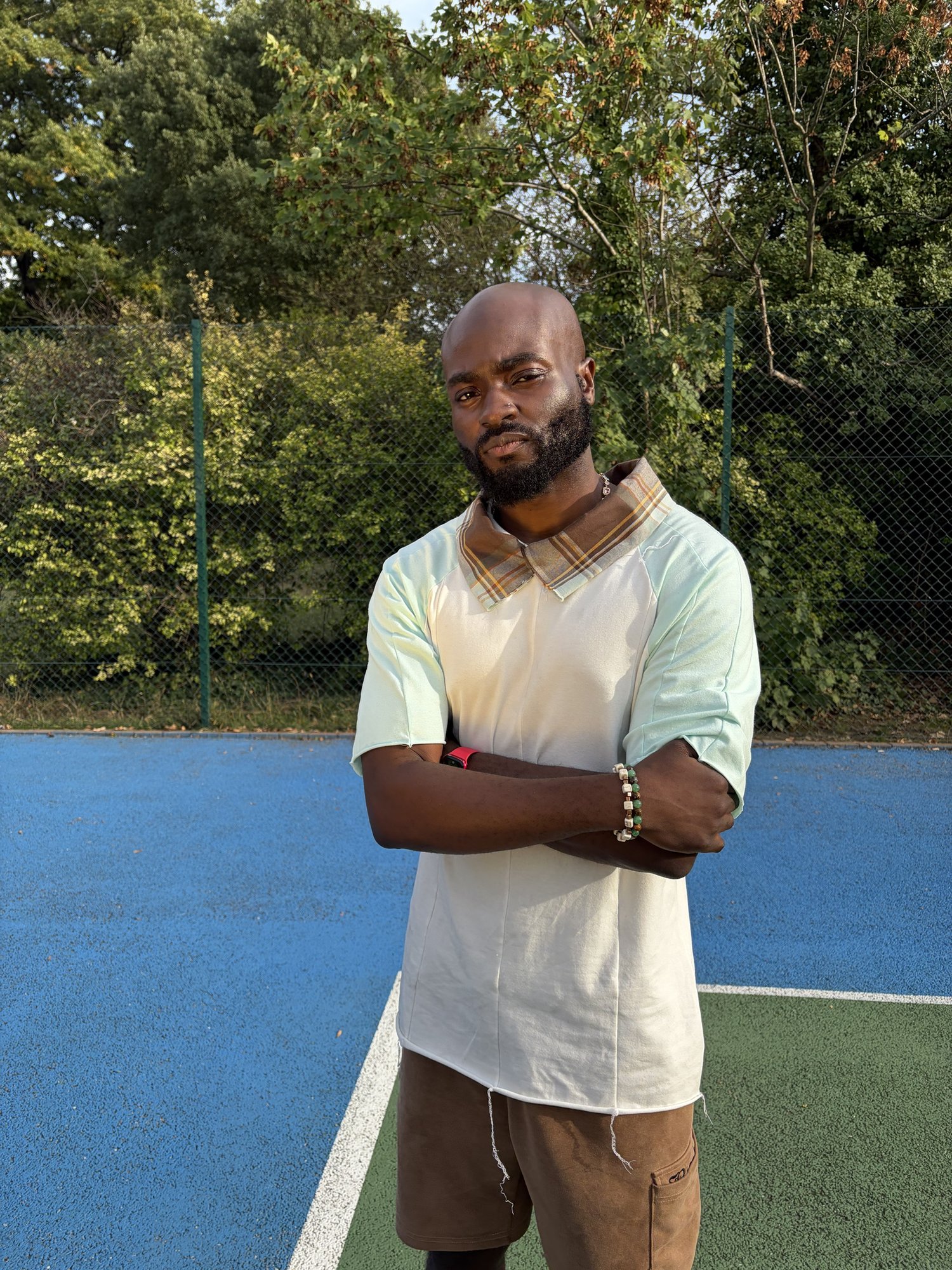 obi standing arms crossed on the court
