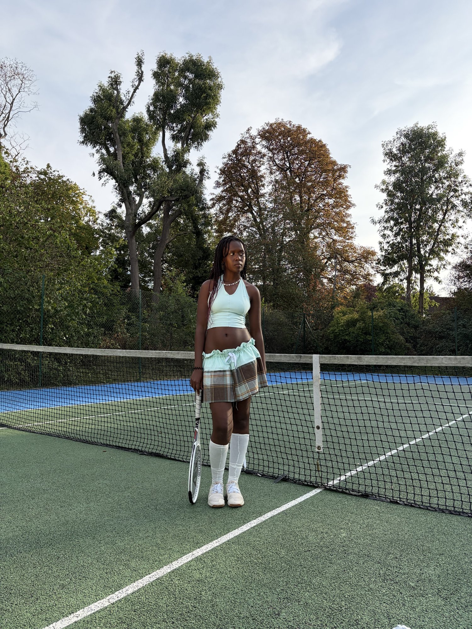 Kah'Nya looking off court, racket in hand