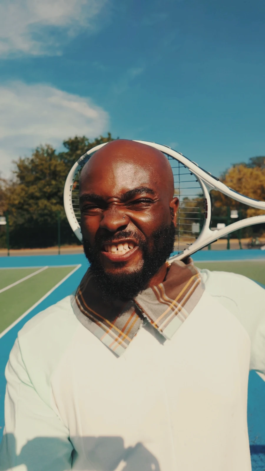 obi grinning with a racket behind his head