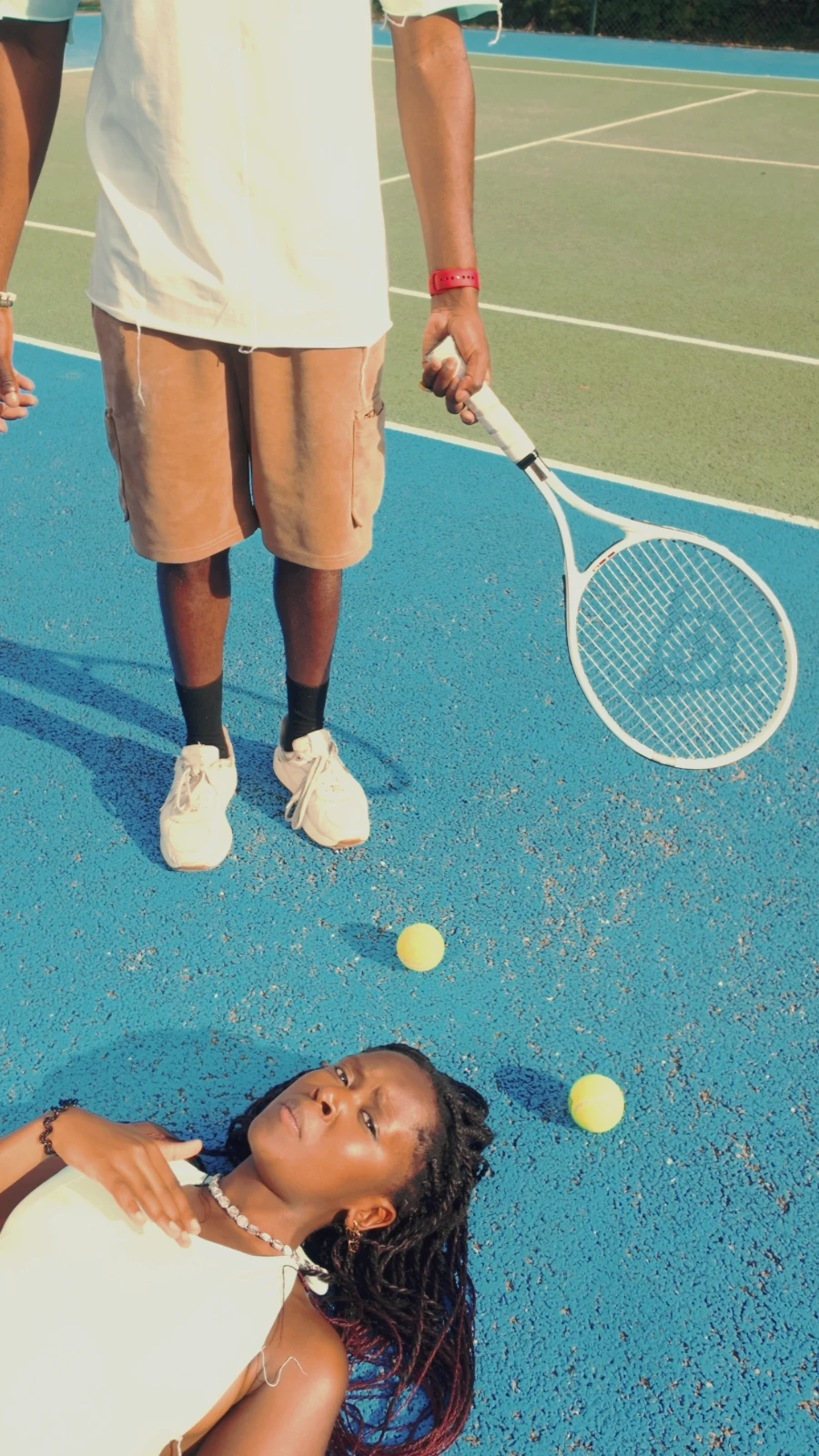 Kah'Nya lying on the court looking up at obi, who stands over her
