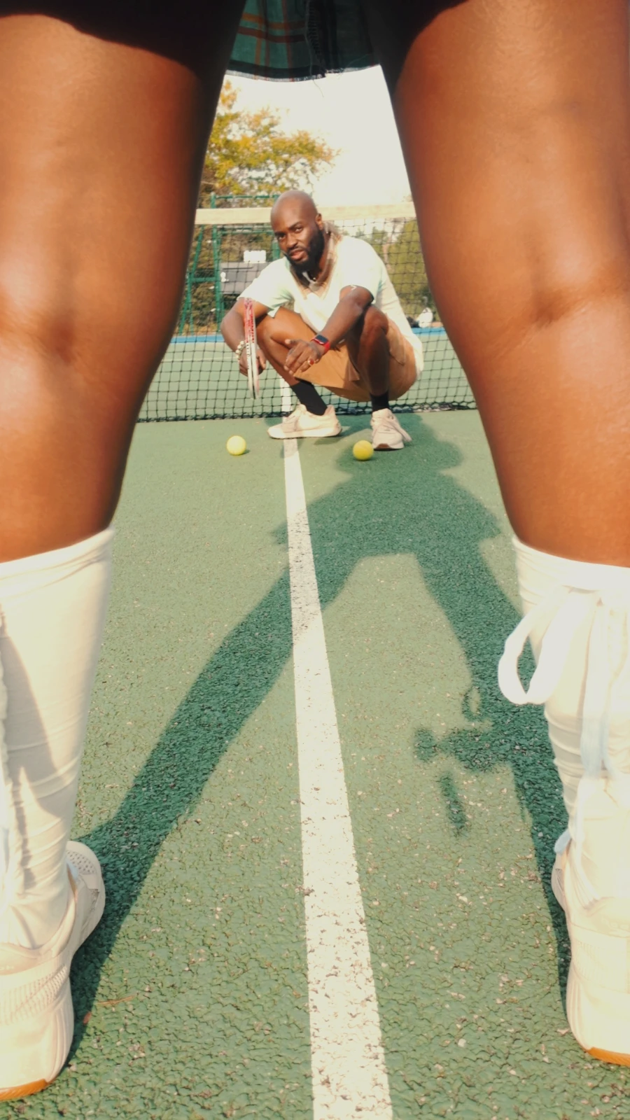 obi crouching on the court, seen through Kah'Nya's legs